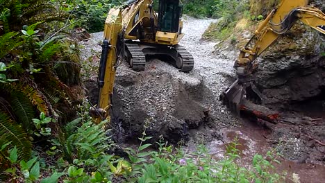 excavators moving dirt and gravel