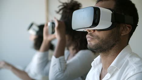 young man wearing vr glasses at office