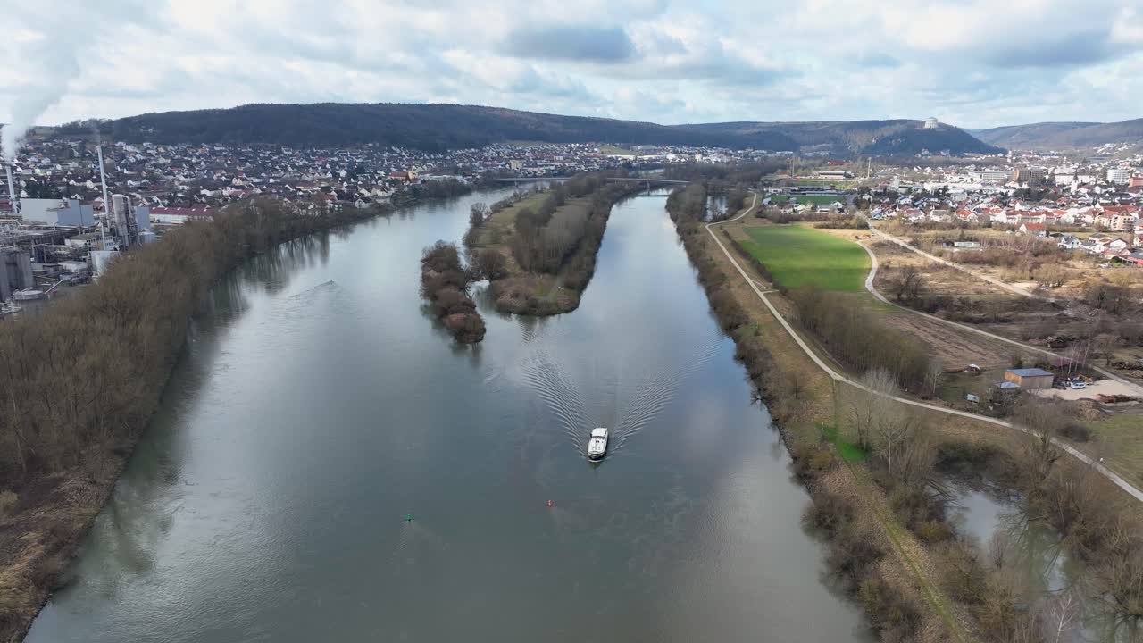 Explore the serene landscape of Kelheim, Germany, from above. This drone shot features the Befreiungshalle and a boat on the river, capturing the region's beauty