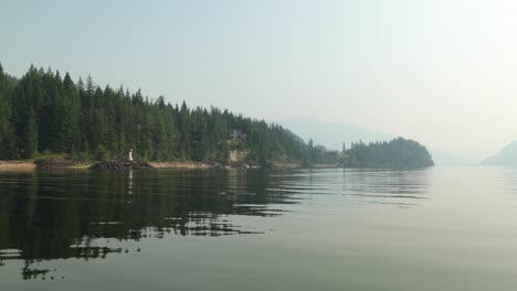 boating on the shushwap passing by the lake shore