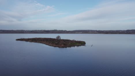 Aerial-View-of-Small-Island-in-a-Lake,-Winter-Landscape---Truck-Shot