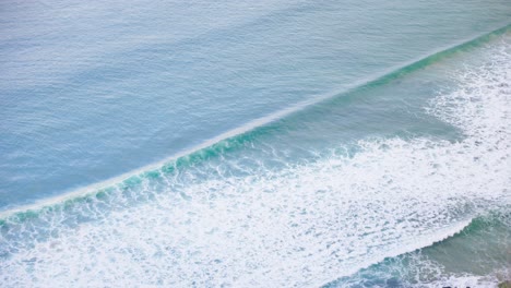 Aerial-view-of-waves-rolling-in