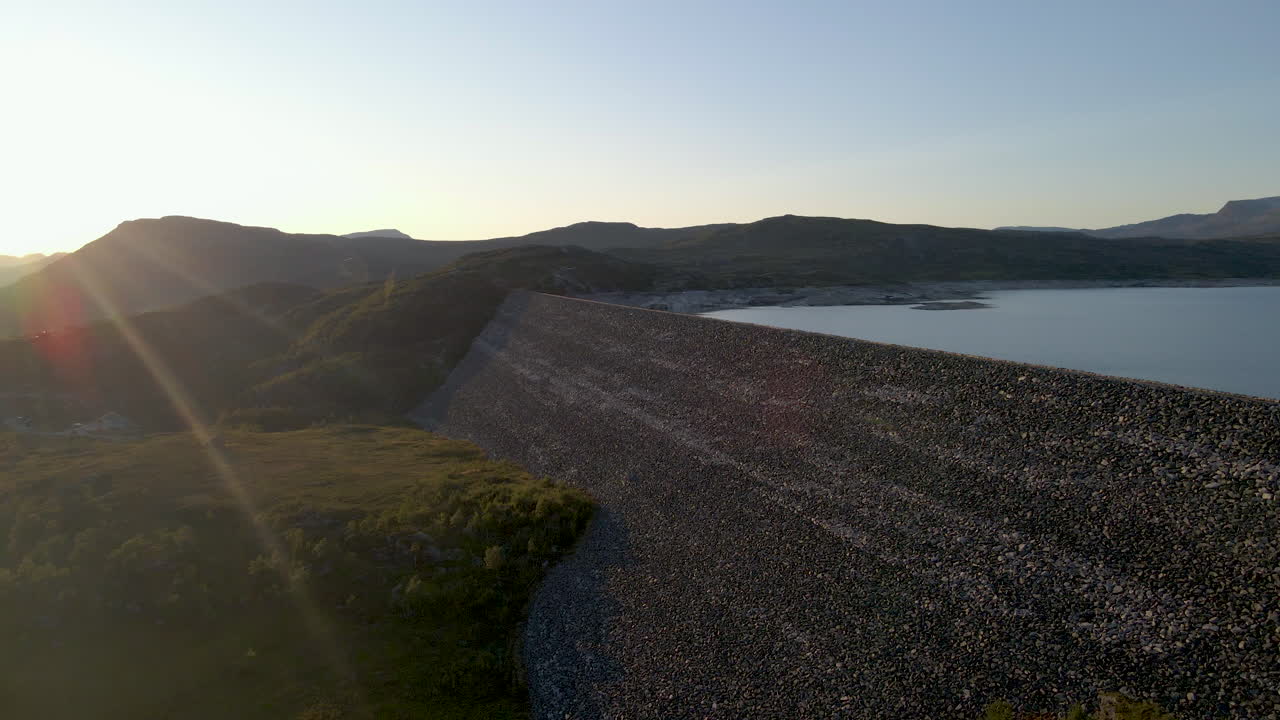 Slow aerial pan showing the embankment of Sysen dam, Hardanger Plateau, Norway