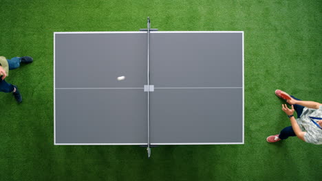 Employees-play-table-tennis-in-office-break-room