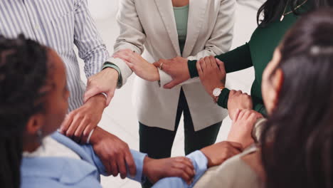 a diverse group of people showing teamwork and unity by linking arms