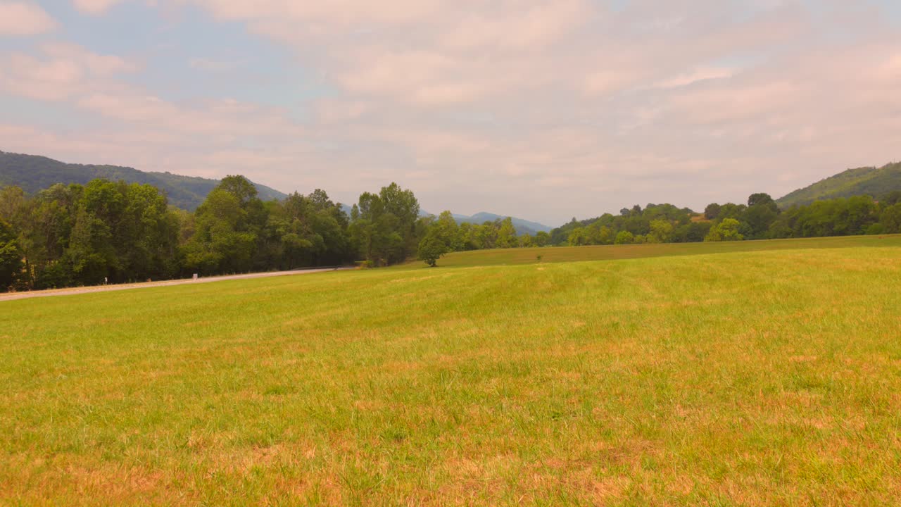 Aerial view of the scenic mountainous landscape of Ariège in southern France, bathed in soft afternoon light