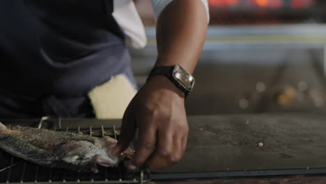 placing a whole fish in a grill basket