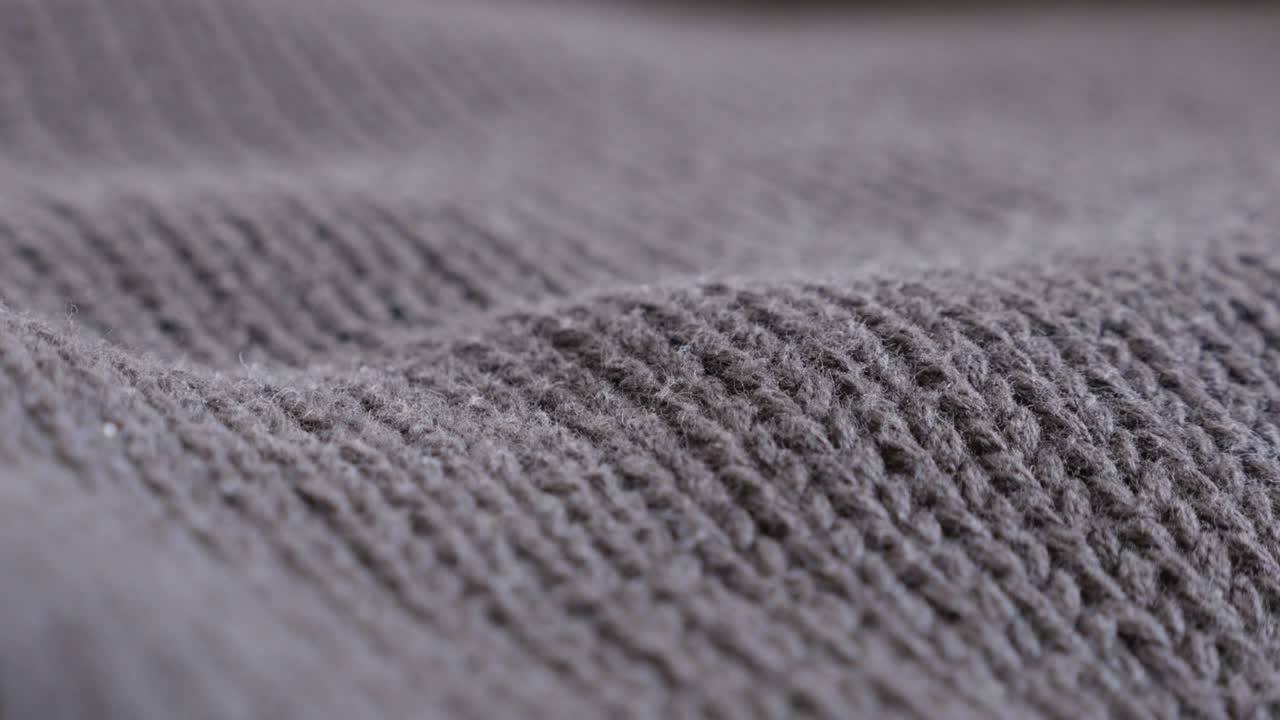 Brown wool ribbing or stockinette stitch knitting work slow tilt 4K 2160p 30fps UltraHD footage - Close-up of warm sweater details and knitwork 3840X2160 UHD tilting video