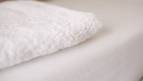 woman smoothing a fresh white towel