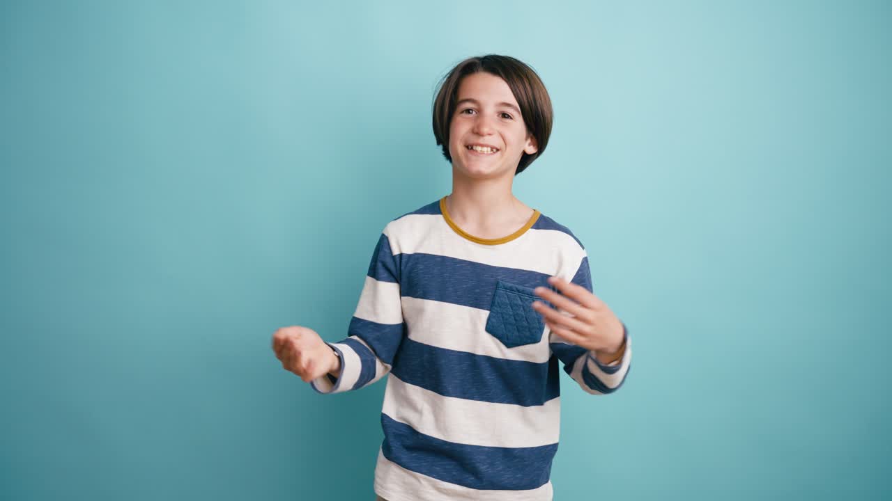 Happy Young Boy Talking and Gesturing in Studio