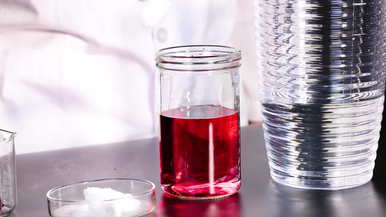 A scientist conducts a chemical reaction using dry ice and red liquid, creating fuming smoke in a laboratory setting