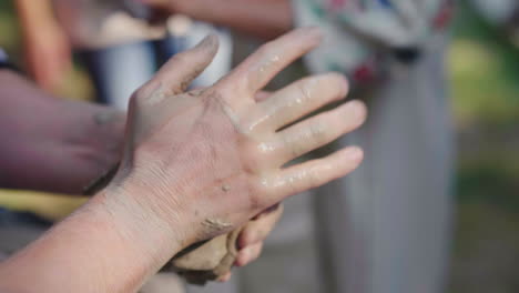 master potter hangs a piece of clay for modeling dishes at the open-air fair close-up 4k slow motion