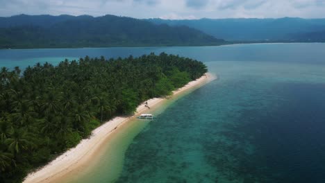 rotating drone shot of cagsalay island with beautiful turquoise seascape in palawan, phillippines.