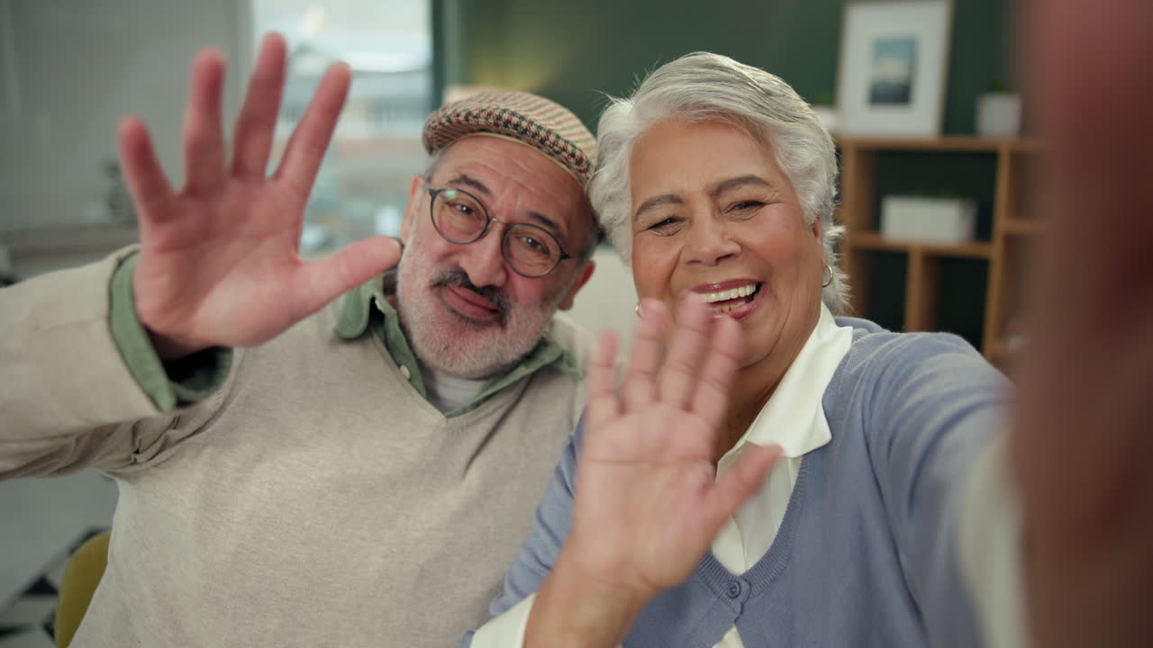 Elderly couple on video call waving