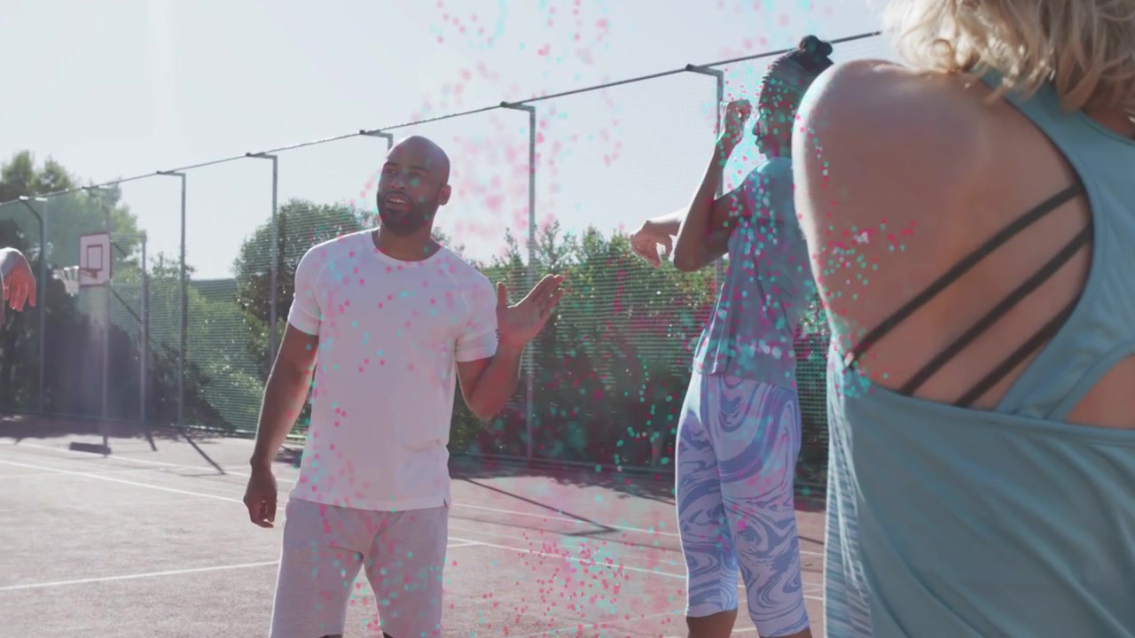 Man raising hand, greeting fitness crew, sparking pink confetti sweeping among group