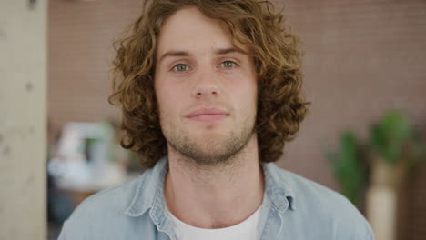 portrait of successful young man looking serious caucasian male student in modern office background real people series