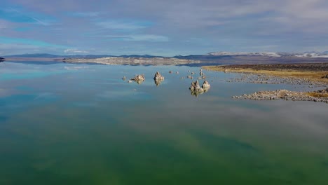 beautiful and inspiring nature drone aerial over mono lake in winter with perfect reflection tufa outcropping in the eastern sierra nevada mountains in california 2