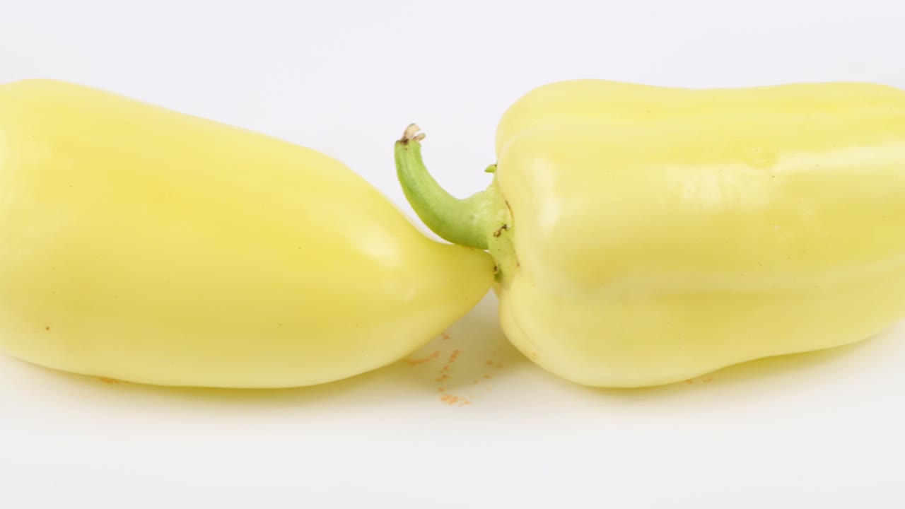 Sweet yellow peppers close-up. Sweet yellow peppers in row. Loop motion. Side view. Rotation 360.