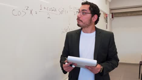 man explaining a concept at a whiteboard