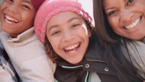 Smiling-African-American-family-faces-outdoors,-handheld-pan