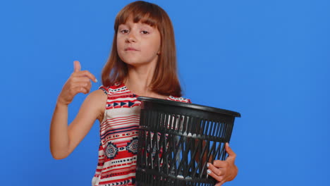 young girl holding a trash can