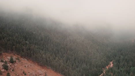 Slow-pan-revealing-rugged-Cheyenne-Canyon,-Colorado,-covered-in-mist