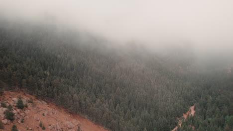 slow pan revealing rugged cheyenne canyon, colorado, covered in mist
