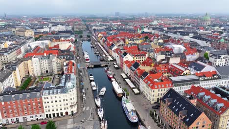 drone flyover beautiful historic nyhavn district and canal in copenhagen, denmark, cityscape