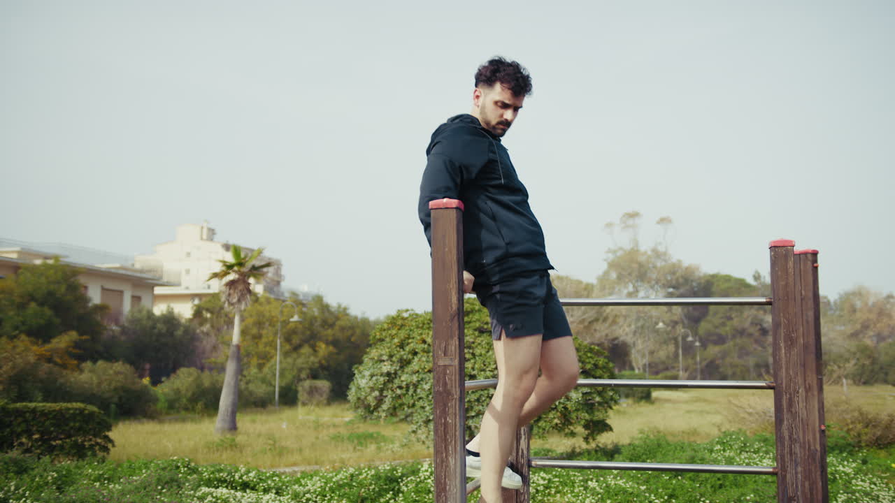 Man Climbs Park Structures During Outdoor Workout