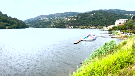 port with small boats somewhere on the douro river in portugal on a windy, sunny day