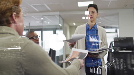 animation of graphs and icons over caucasian woman discussing reports in office