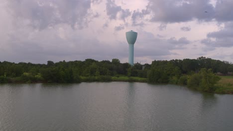 wide angle shot of brays bayou and large light blue water tower in alief area in houston