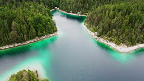 scenic aerial of forest lake, lake eibsee in bavarian alps, germany