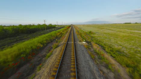 train tracks through a countryside landscape