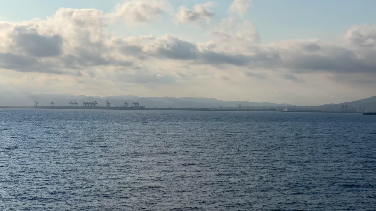 Barcelona commercial port cargo ship cranes in the background