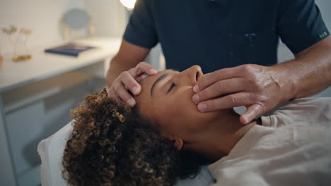 woman lying chiropractic therapy in health center closeup. man doctor massaging