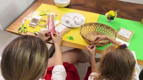 mother and daughter crafting easter basket decorations