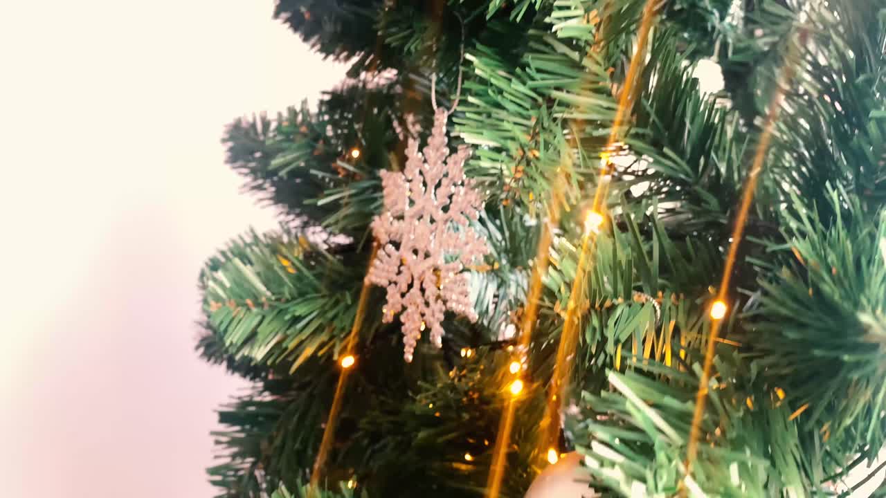 Beautiful green decorated Christmas tree. Christmas tree with bulbs, stars and lights. Review of a decorated Christmas tree on a white background.