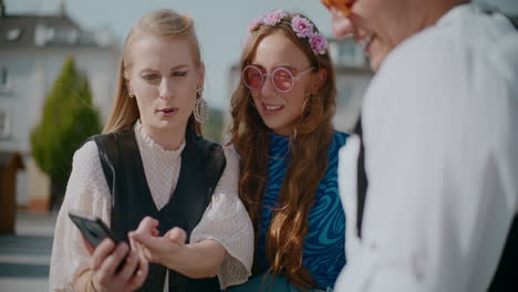 friends looking at a phone outdoors