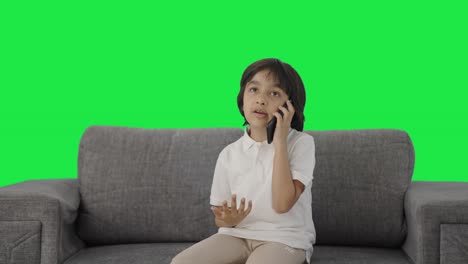 Serious-Indian-boy-talking-on-phone-Green-screen