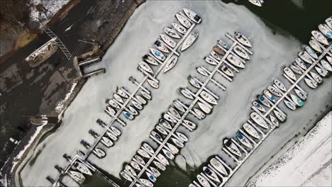 Top-down-shot-of-frozen-marina-during-winter-at-Lighthouse-Landing-in-Grand-Rivers,-Kentucky