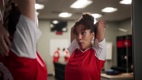 women athletes stretching in locker room