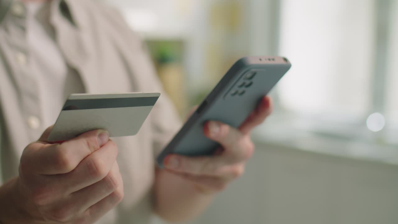Man Doing Online Shopping with Smartphone and Credit Card