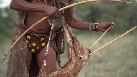 a native man placing an arrow into his bow