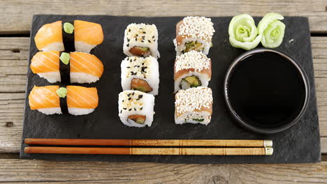 set of assorted sushi served on black stone slate