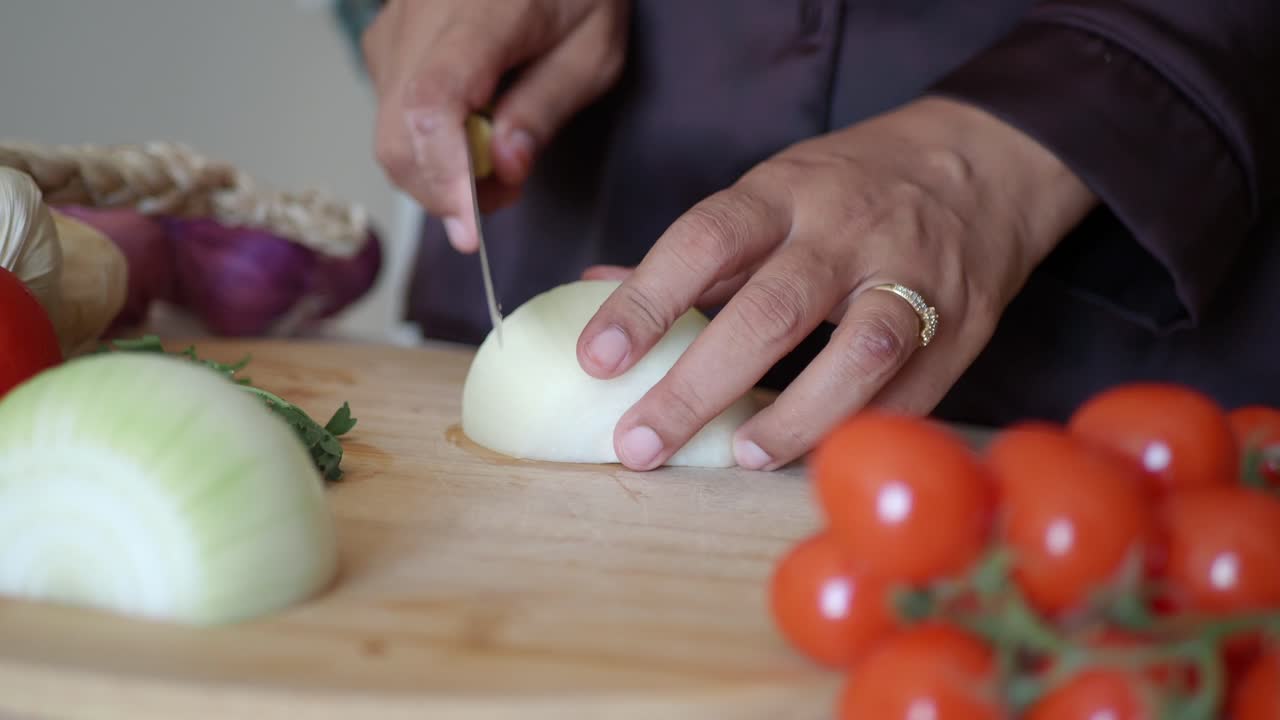Woman Chopping Onions and Tomatoes in the Kitchen