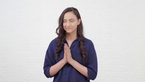 indian girl doing namaste and greeting