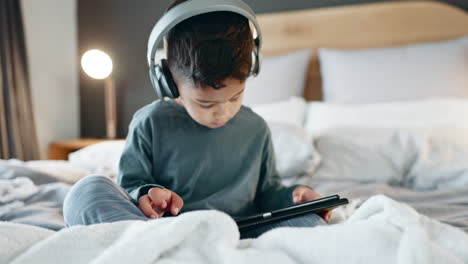 boy, kid and tablet with headphones in bedroom