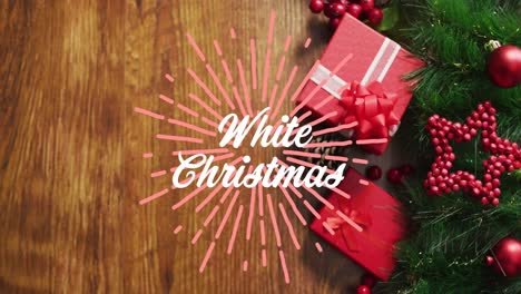 Animation-of-white-christmas-over-presents-an-decorations-on-wooden-surface