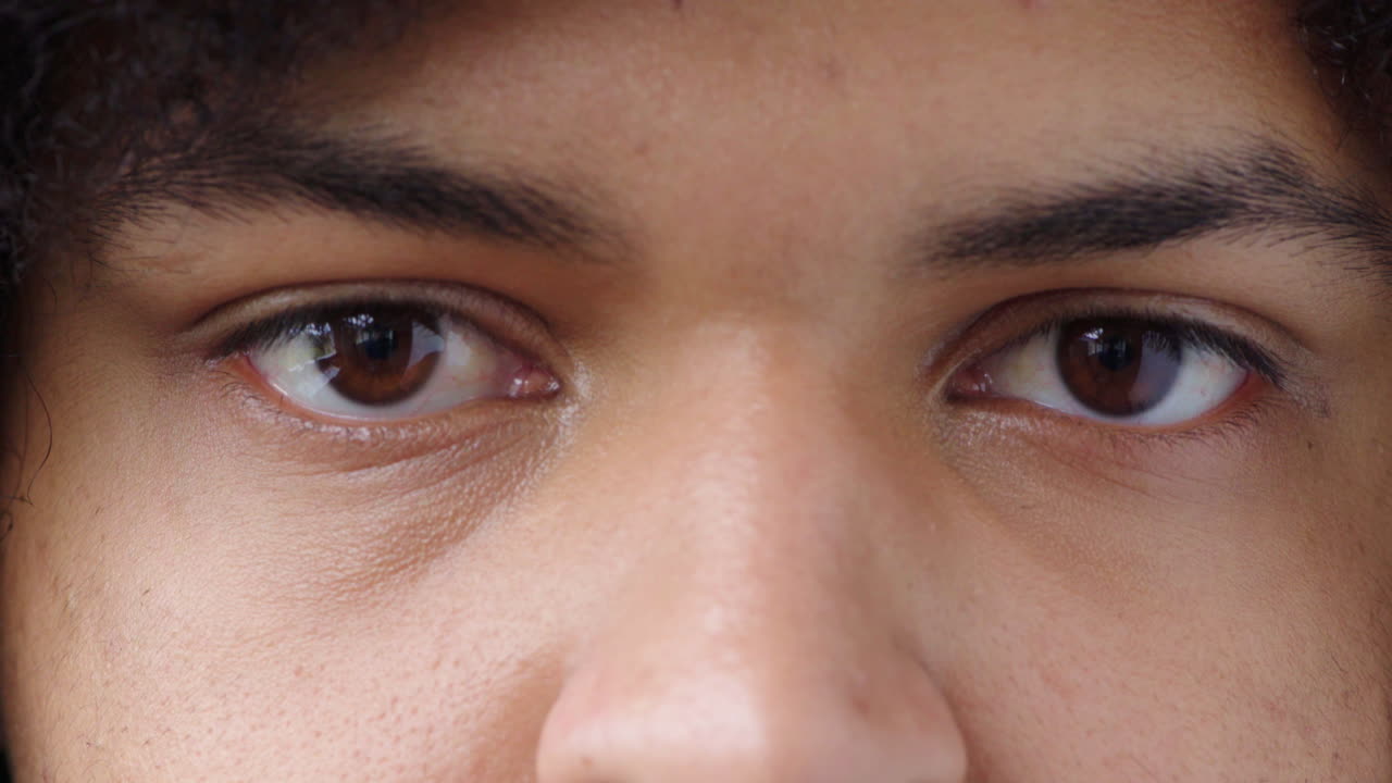 Closeup of a man staring and blinking
